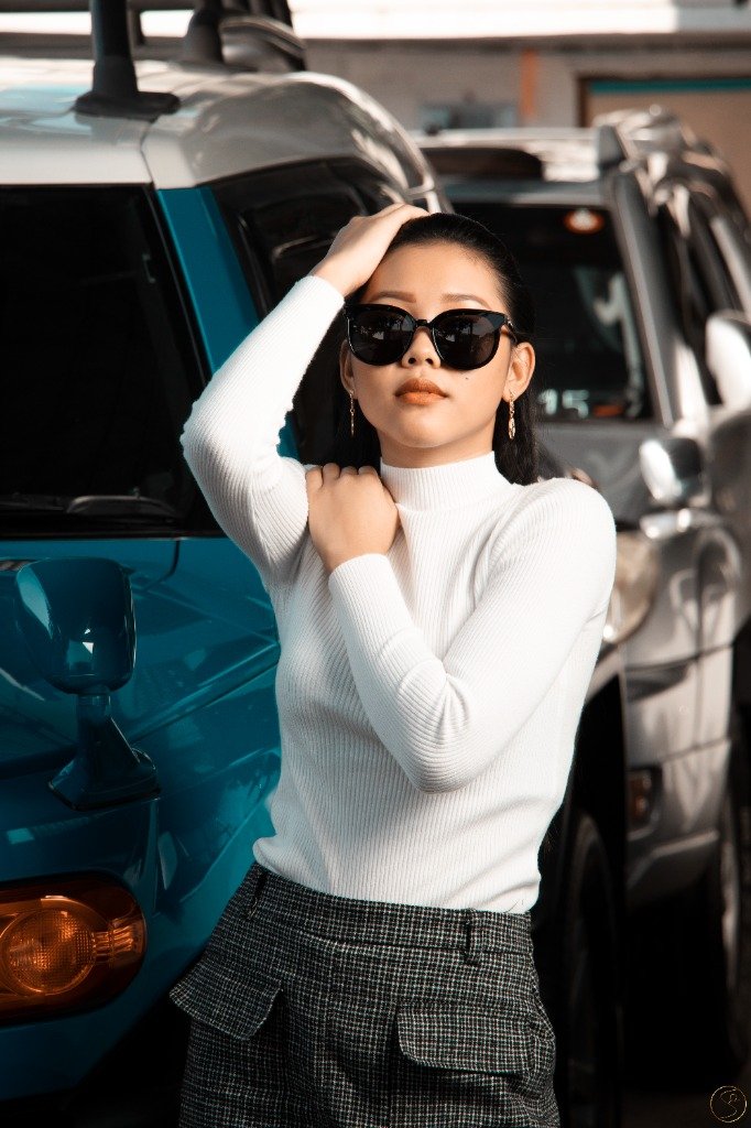 Fashion portrait of a woman in sunglasses beside a car, presented in diagonal photographic strips